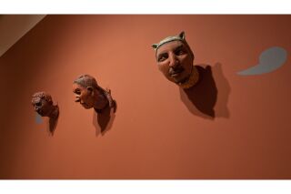 Photo of gallery wall with 3-D sculpted heads