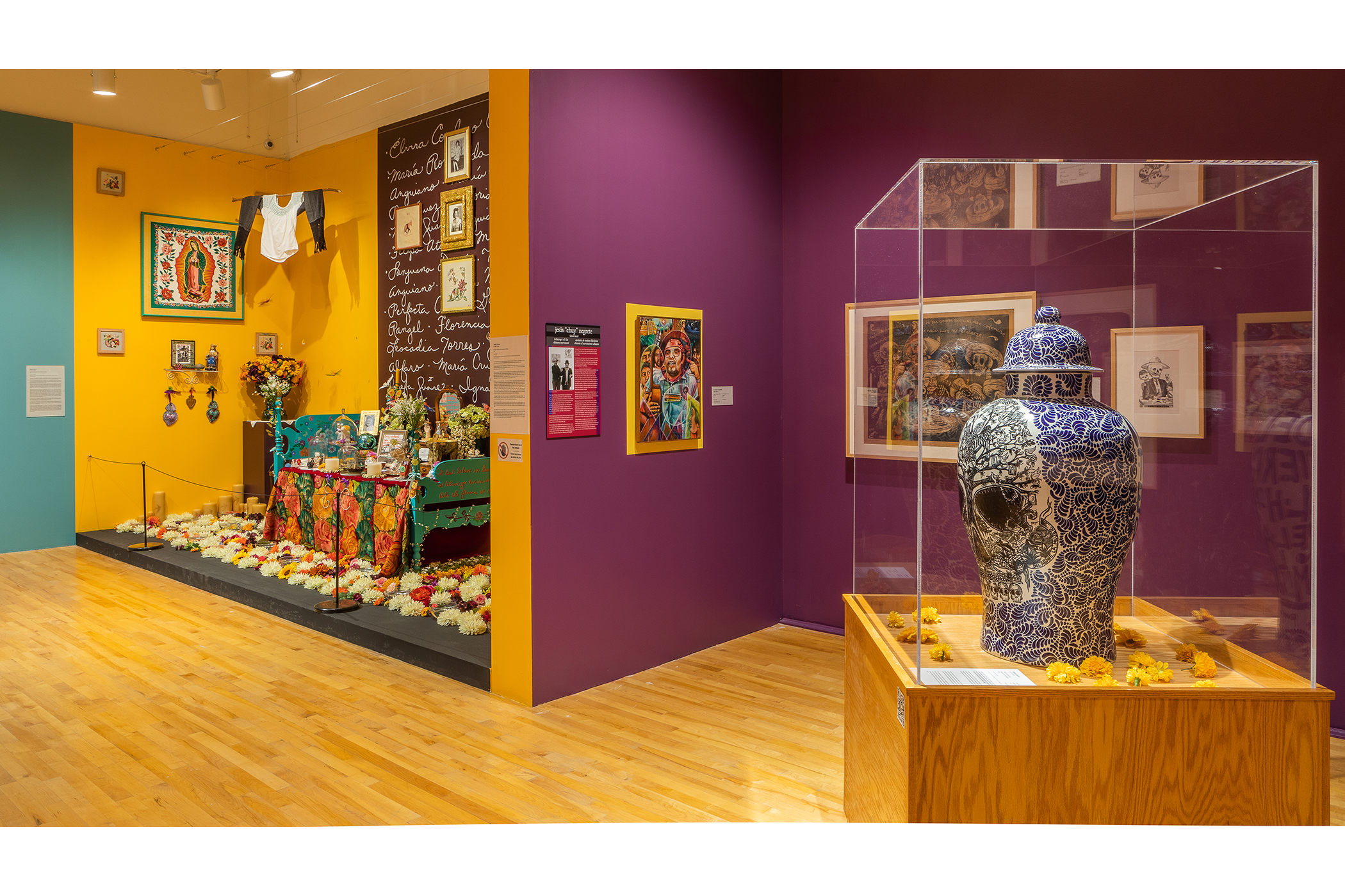 A large tibor is in a vitrine surrounded by installations and paintings.