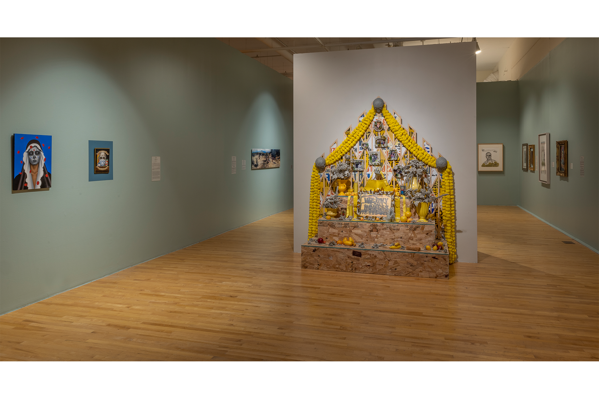 An overview shot of the artwork on display in the teal room.