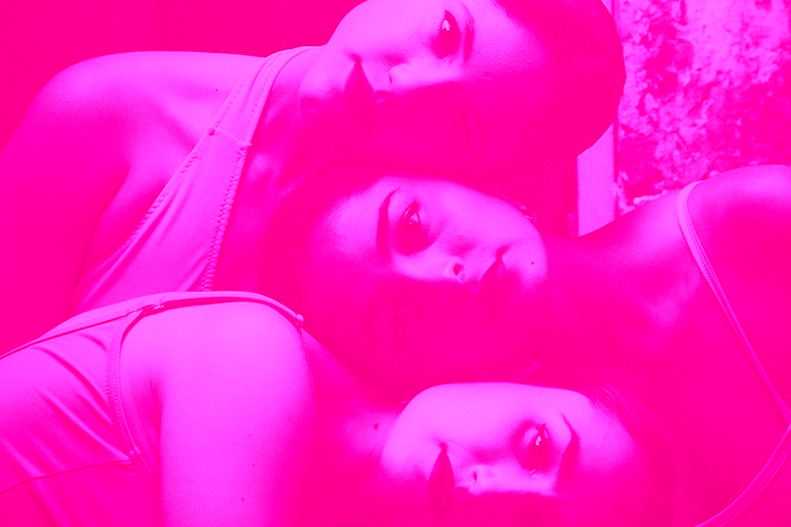 A hot pink image of three sisters embracing