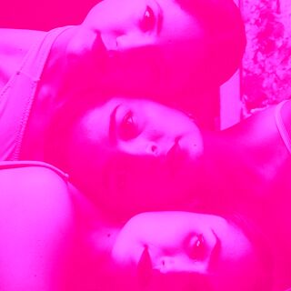 A hot pink image of three sisters embracing