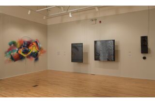 Four art pieces on the gallery walls: An abstract sprayed paint and multimedia Cold steep pieces.