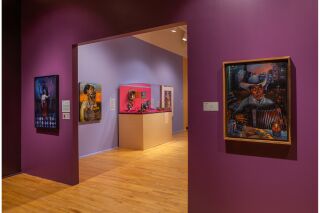 Two paintings on either side of a door frame into the next exhibition room