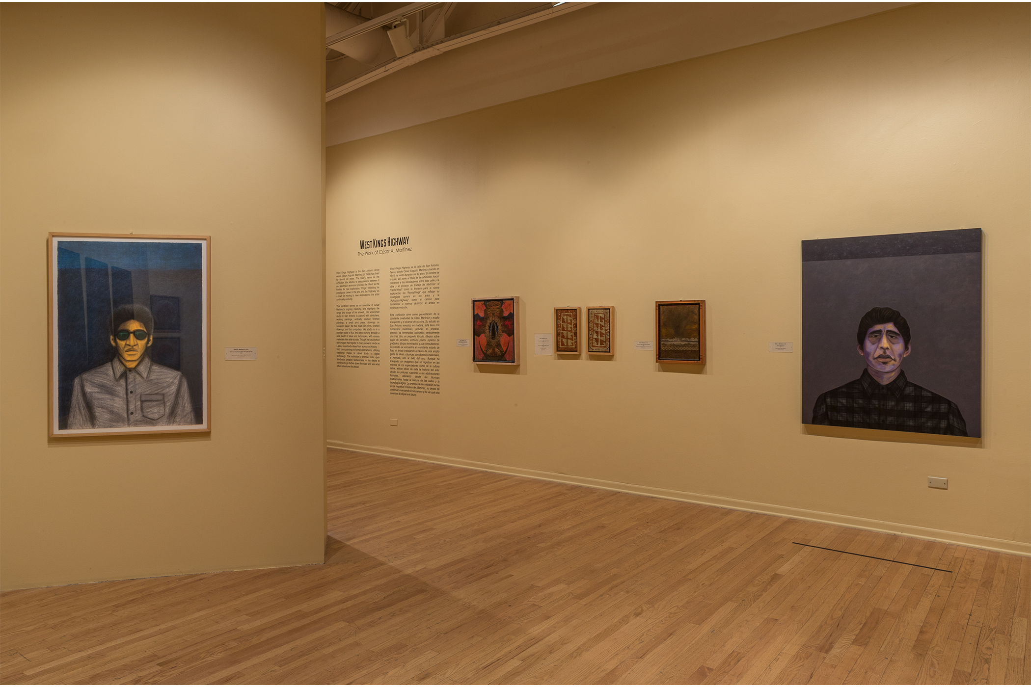 Artwork hangs on the walls in the gallery space.