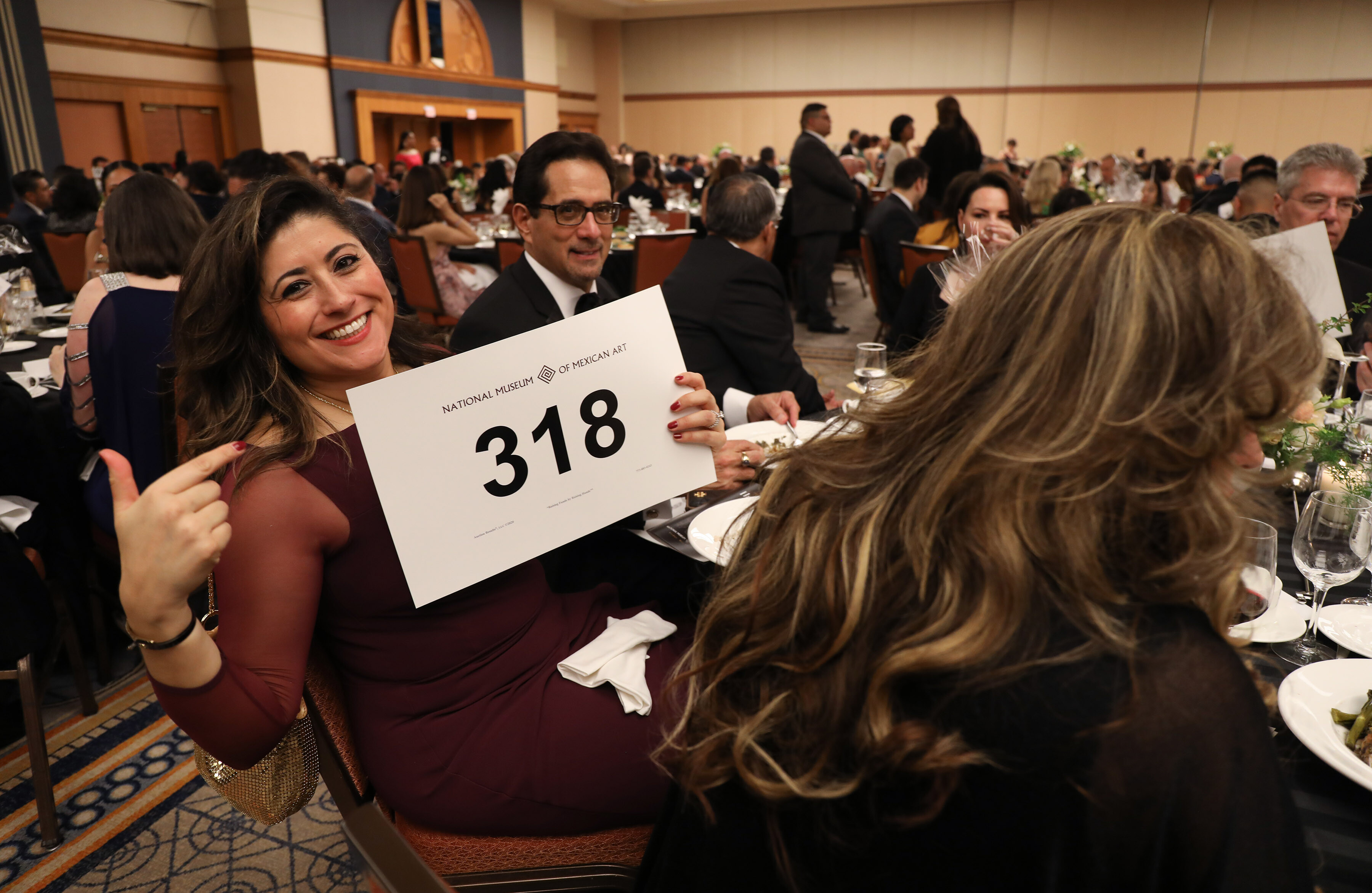 Trustee Eve Rodriguez bids on a live auction item.