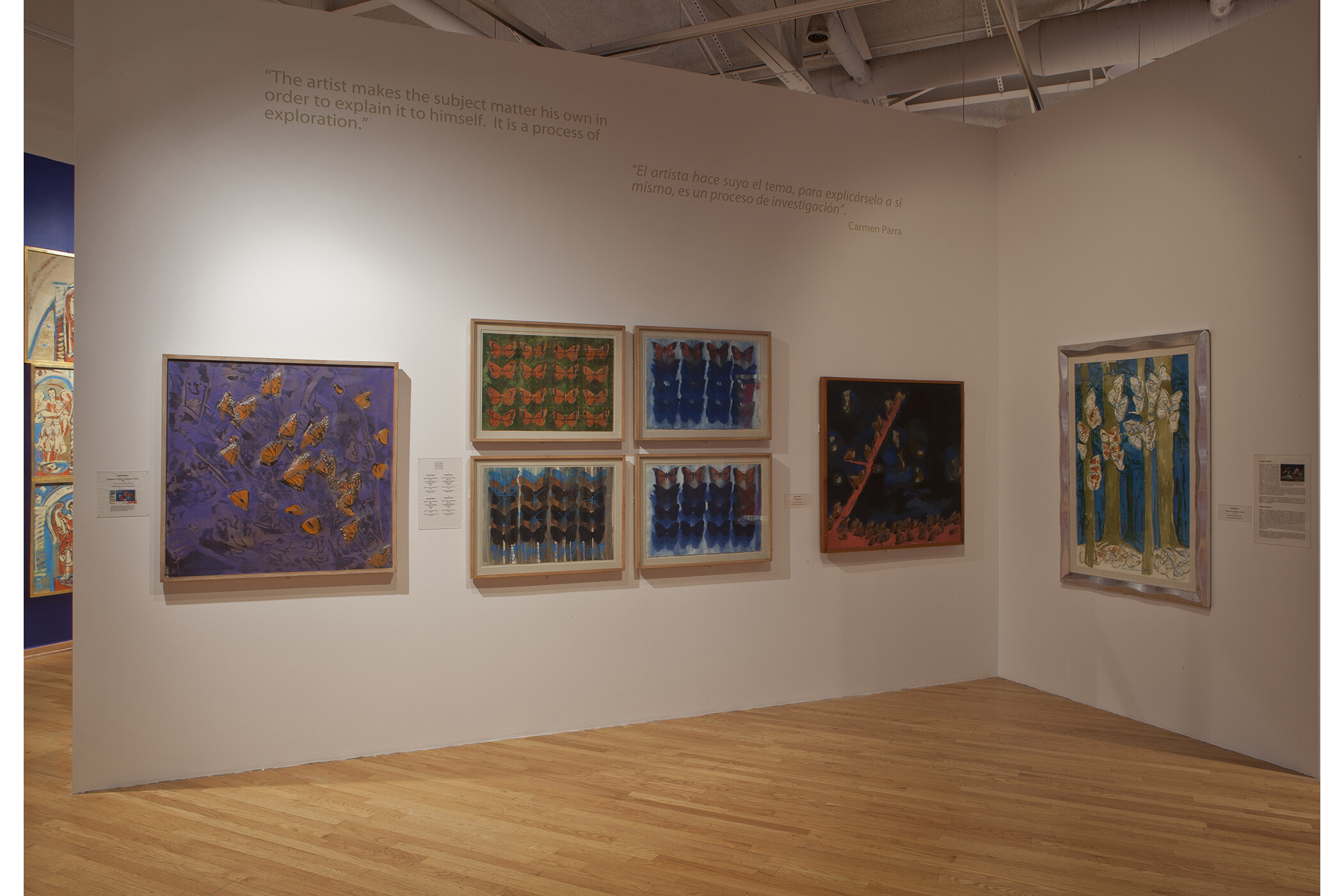 Seven different art pieces hang on the walls, all following the theme of monarch butterflies.