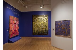 pink, orange, brown painting; a gold yellow monochrome art piece of a cathedral, and an abstract painting depicting monarch butterflies.