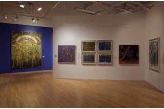eight works of art hang on the gallery walls.