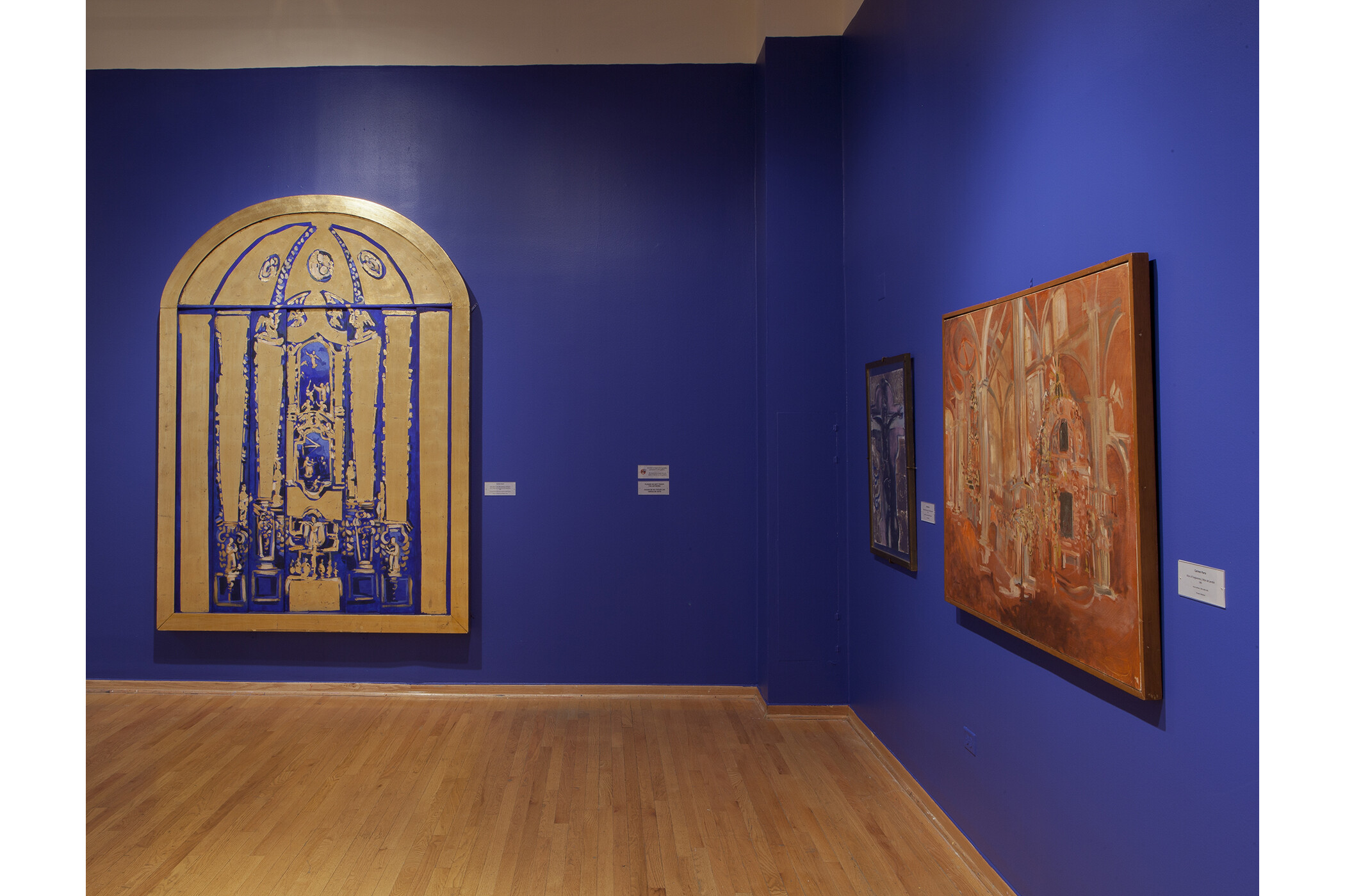 an art piece that's dark blue and gold, and an art piece that's orange monochrome