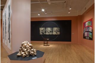 An overview shot of the exhibition in a beige gallery room.