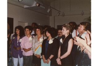 Color photograph of artists at exhibit