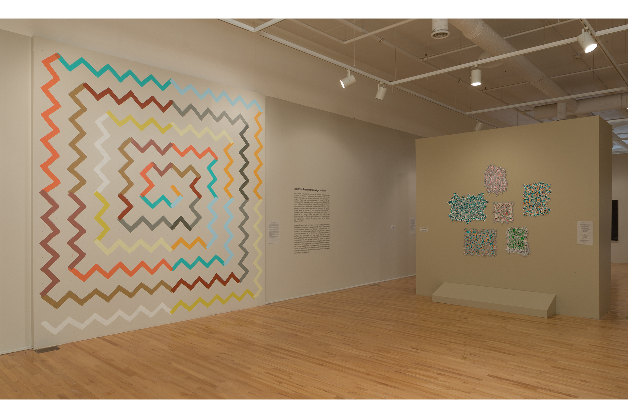 Two art pieces: left side zigzag paint stroke swirling in square direction; right side, a collections of acrylics on paper in abstract geometric forms