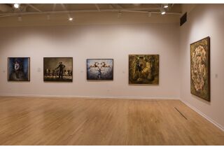 Image of two gallery walls with five hanging paintings total