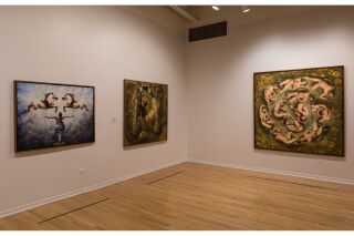 Image of two gallery walls with three hanging paintings total