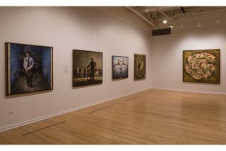 Image of two gallery walls with five hanging paintings total