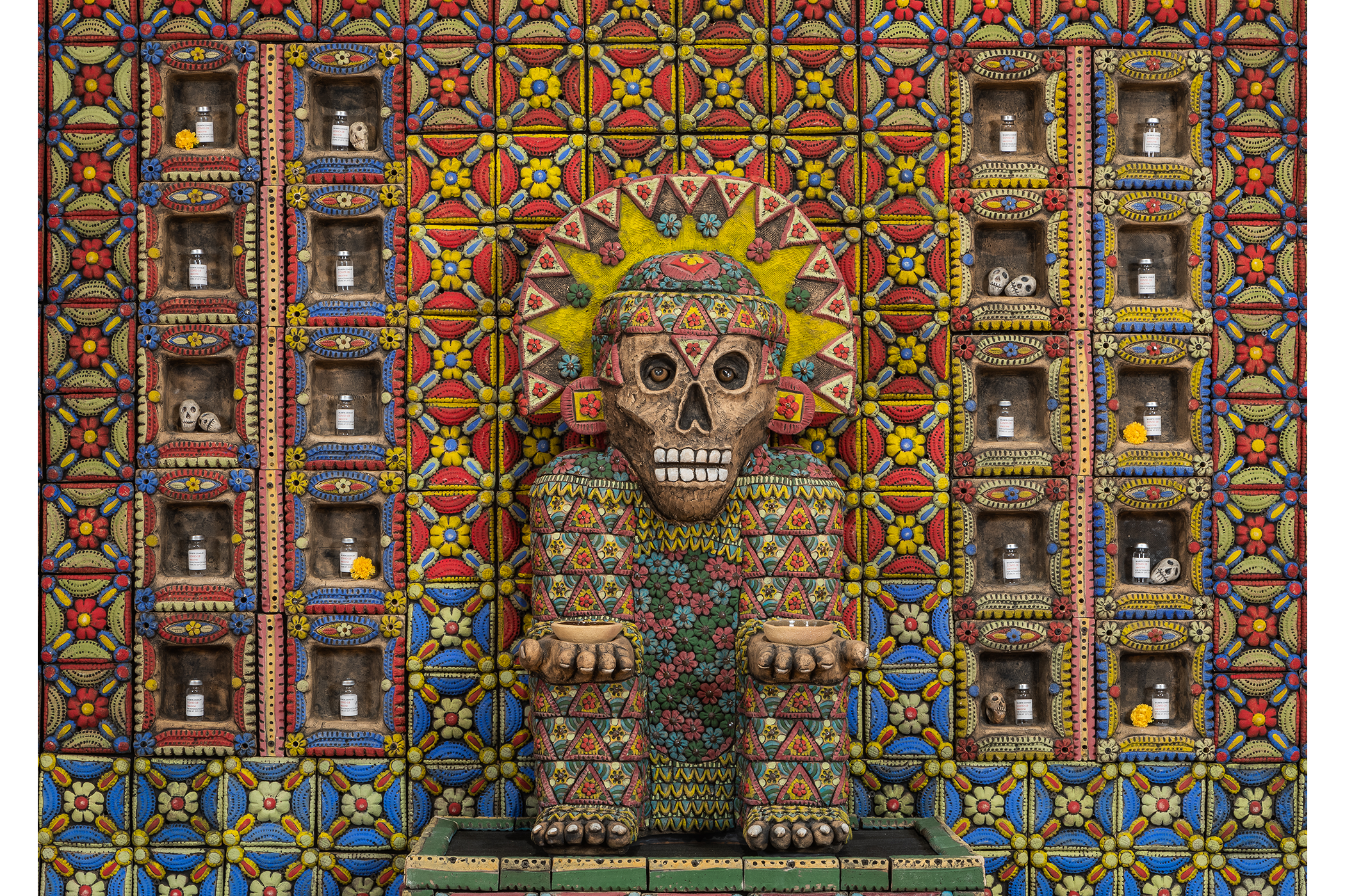A ceramic structure of a seated Aztec deity