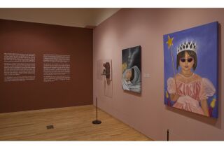 Photograph of two gallery walls. Left wall shows information on exhibit and right wall shows three pieces of art