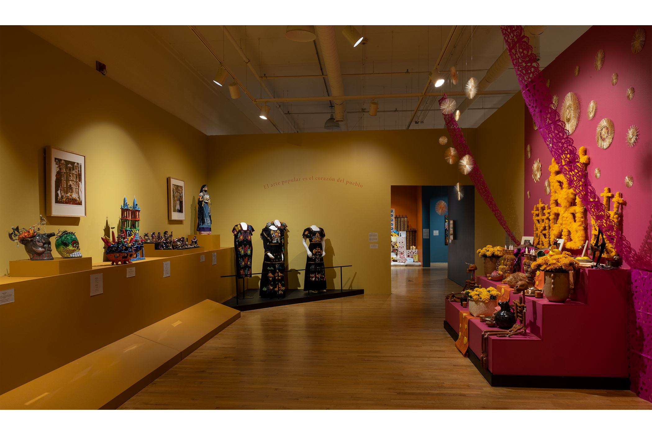 Gallery overview shot of the yellow and pink exhibit room.