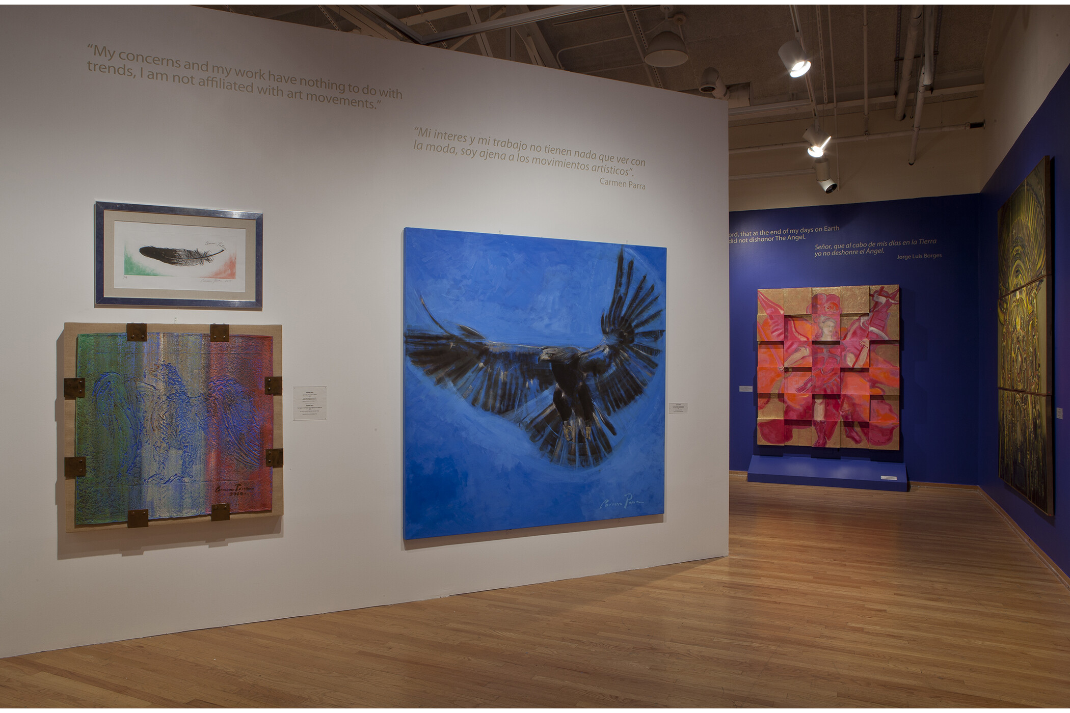 five art pieces hanging on gallery wall