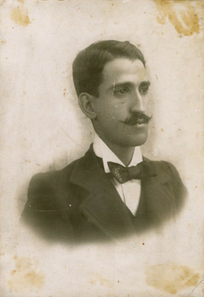 A old photo of a man in a suit and bow tie