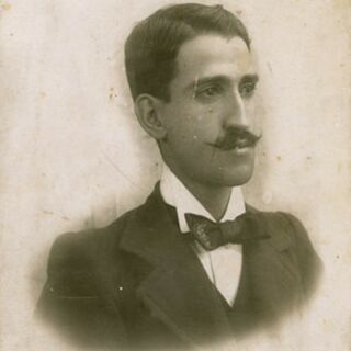 A old photo of a man in a suit and bow tie