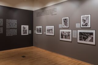 Photo of two gallery walls with text and black and white photographs