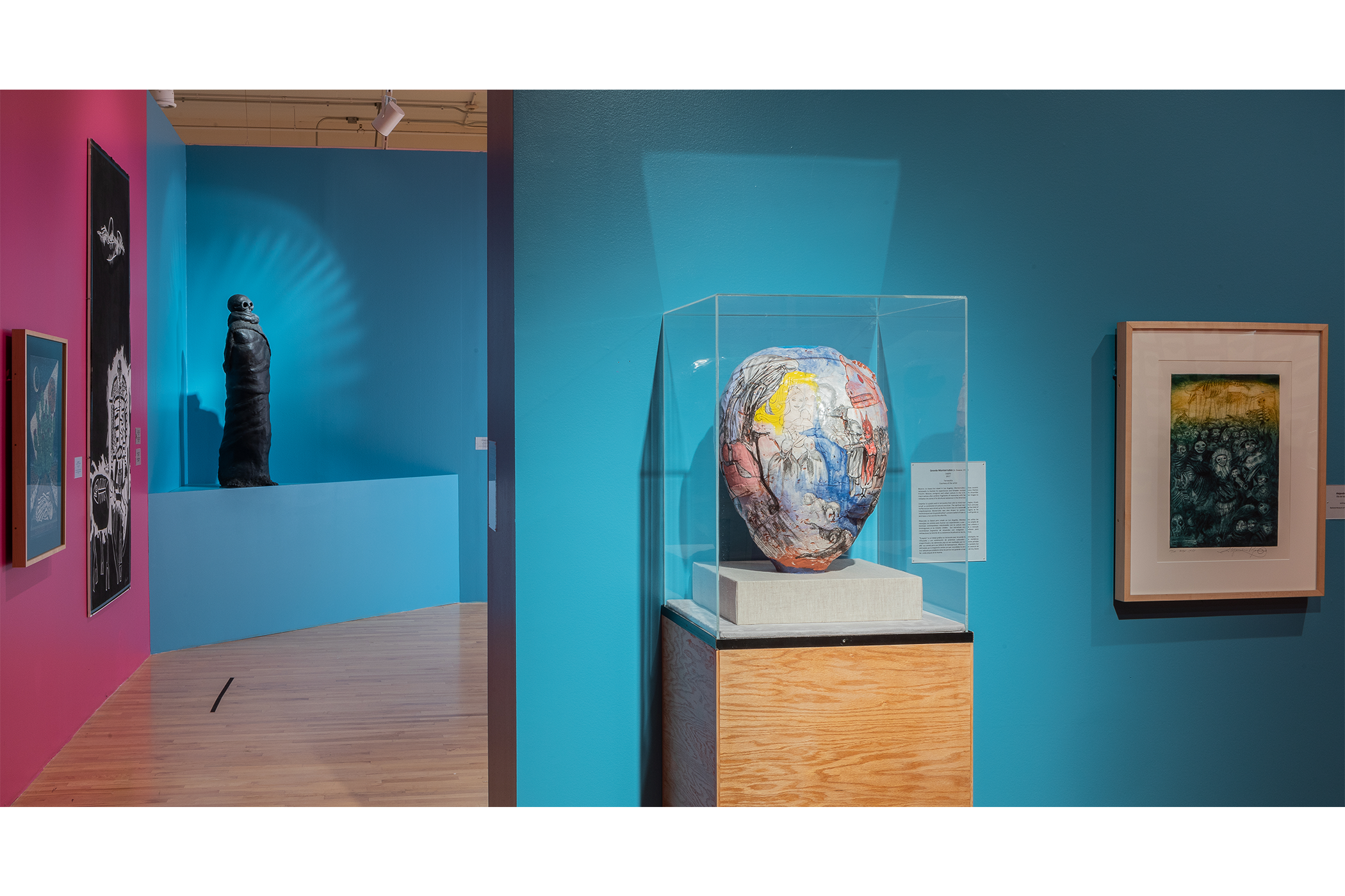 A round terracotta object painted with imagery of dogs; An etching depicting a crowd with disfigured masked faces.