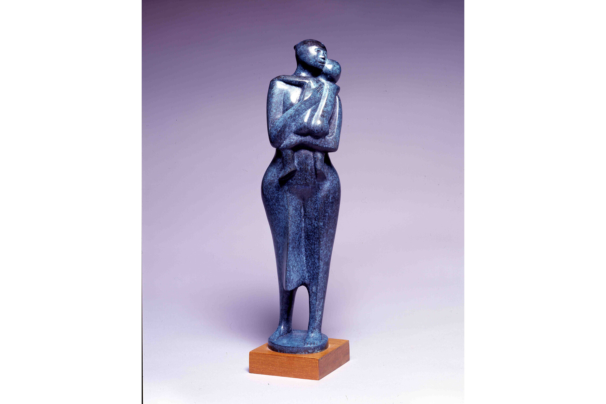 Sculpture of woman holding naked child in her arms