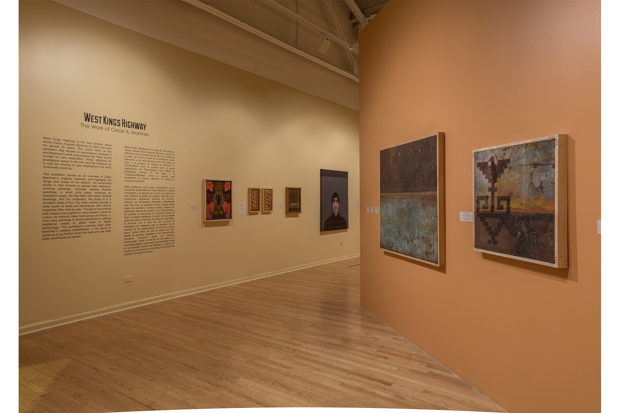 The introduction text alongside five hanging pieces of art. Two hanging art pieces on the wall to the right.