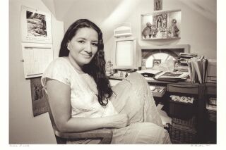 Photo of Sandra Cisneros at a desk