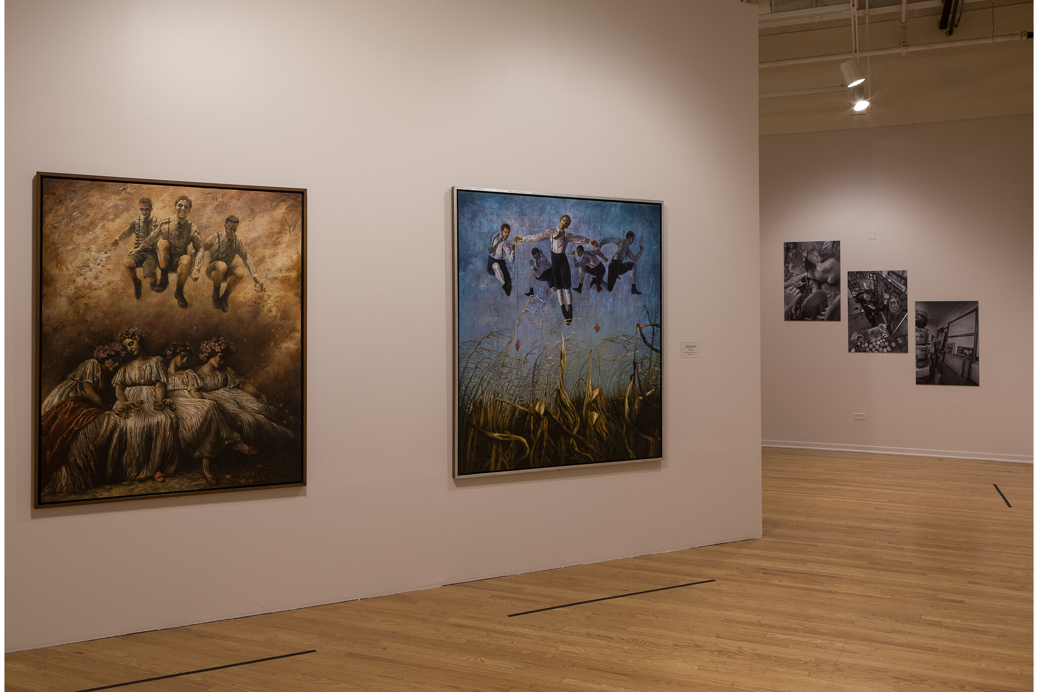 Image of two gallery walls with five hanging paintings total