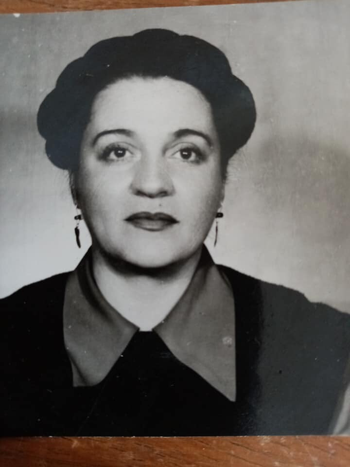 A woman with braided hair poses for a photo