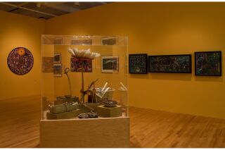 Photo of two gallery walls and 3-D art