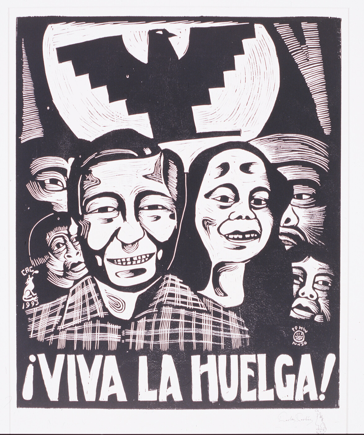 Black and white image of crowd with Aztlan imagery and “viva la huelga” displayed on a a banner
