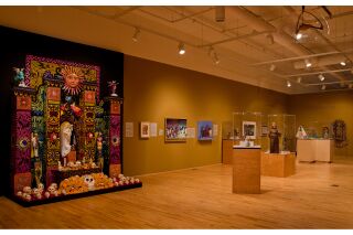 Photo of gallery with altar, 3-D art, and paintings