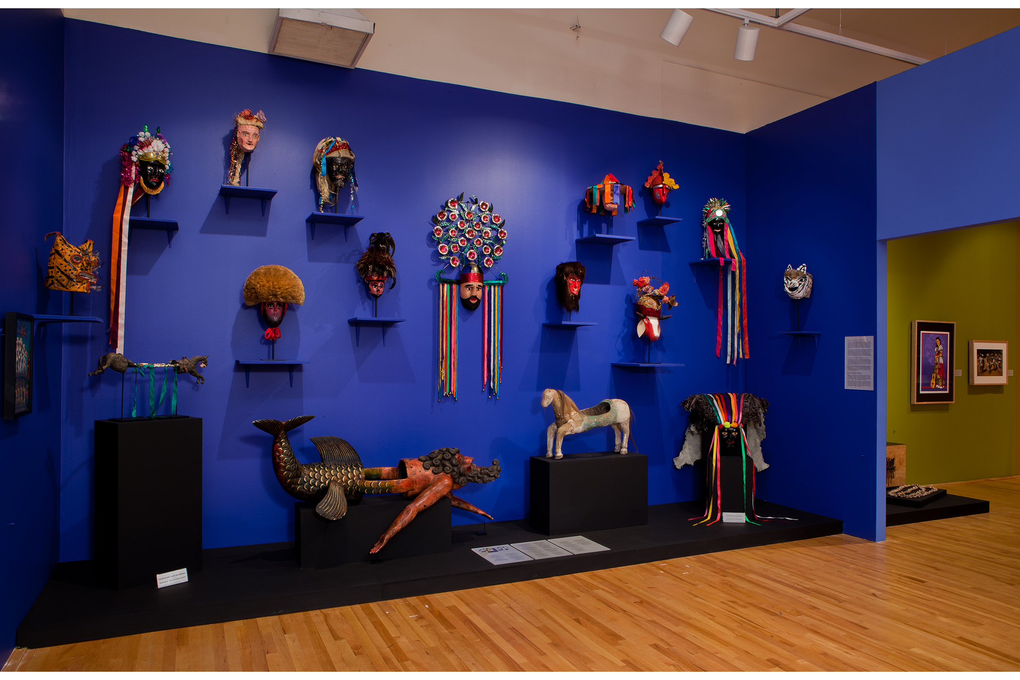 gallery wall full of 3-D art and masks