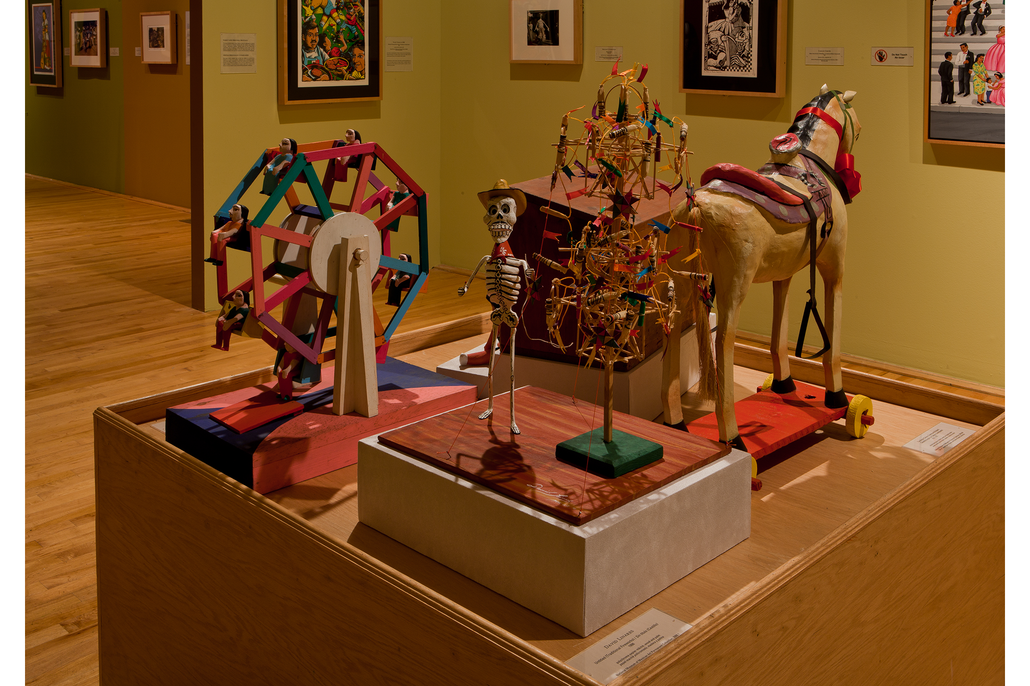 close up view of the polychrome wood and papier-mâché art pieces from previous image.