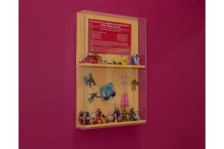 A display case filled with a variety of children's toys and figurines.