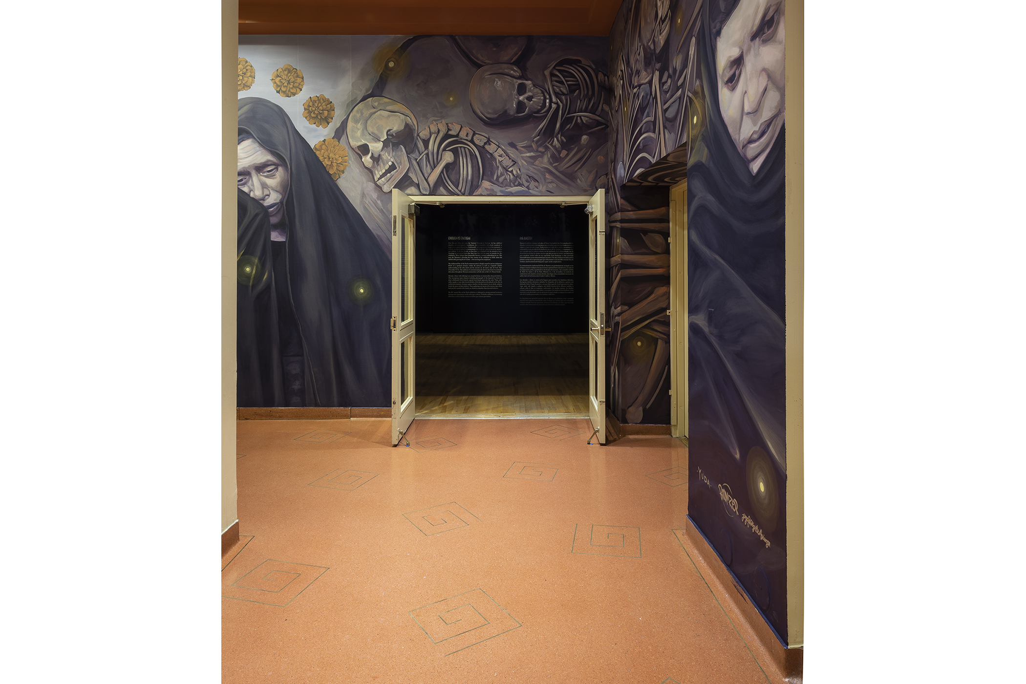 Facing the entrance of the main gallery from the hallway with the entrance doors open.