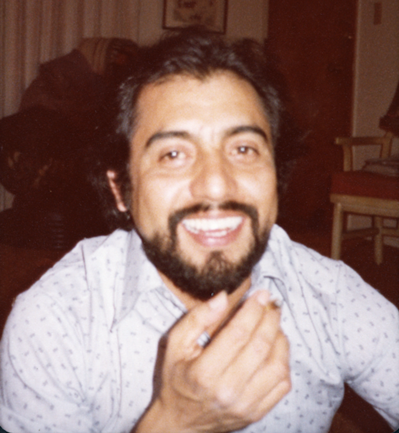 A bearded man smiles for a photo