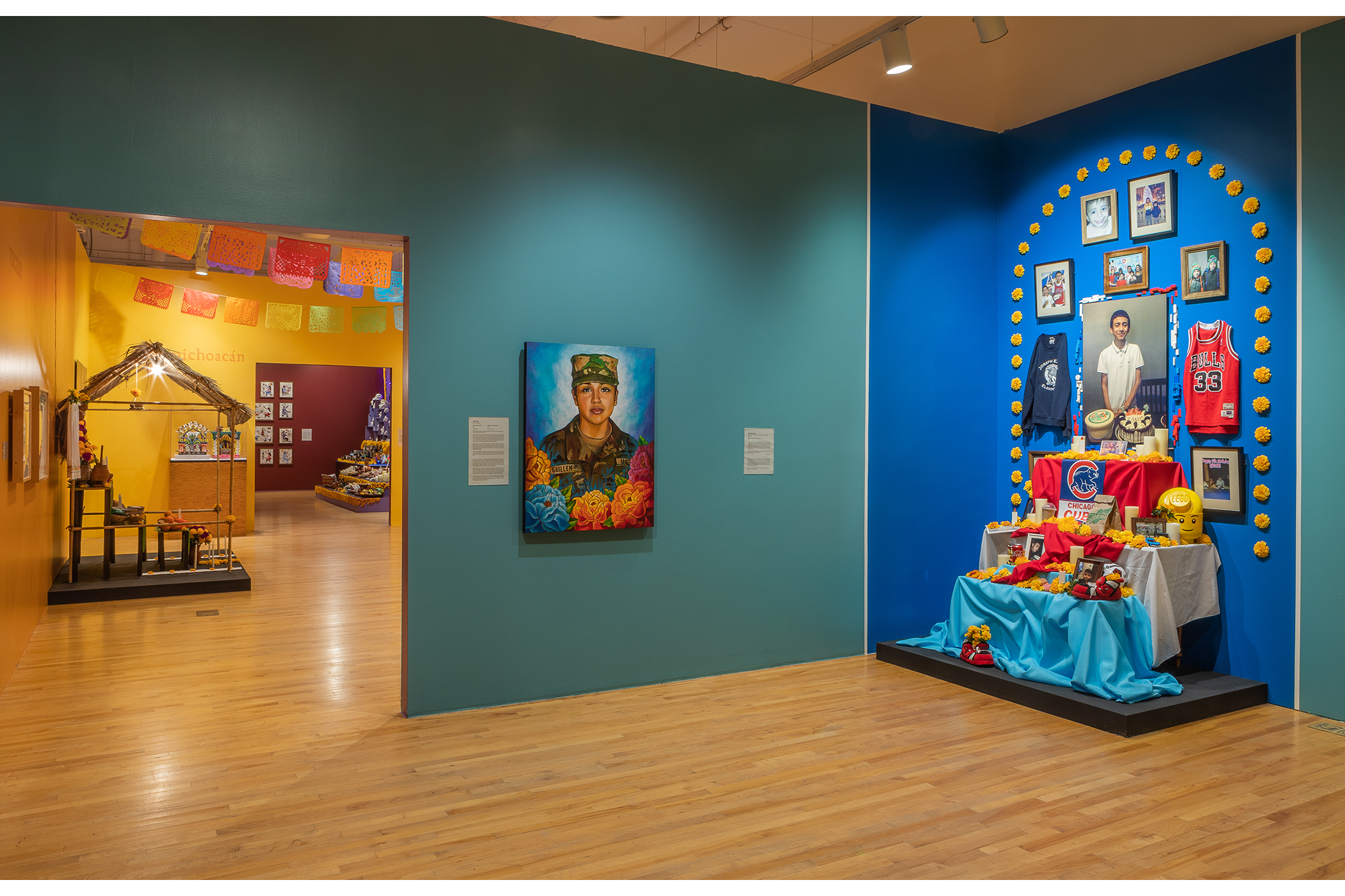 A painting of Vanessa Guillén is next to an ofrenda dedicated to Adam Toledo