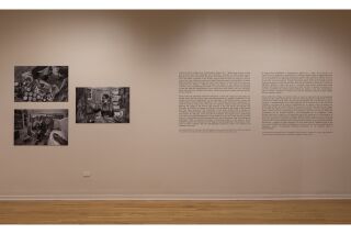 Gallery image of exhibit description on right side and three black and white photographs of the artist on left side