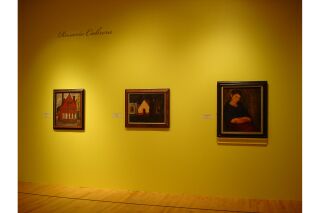 One gallery wall visible with three paintings