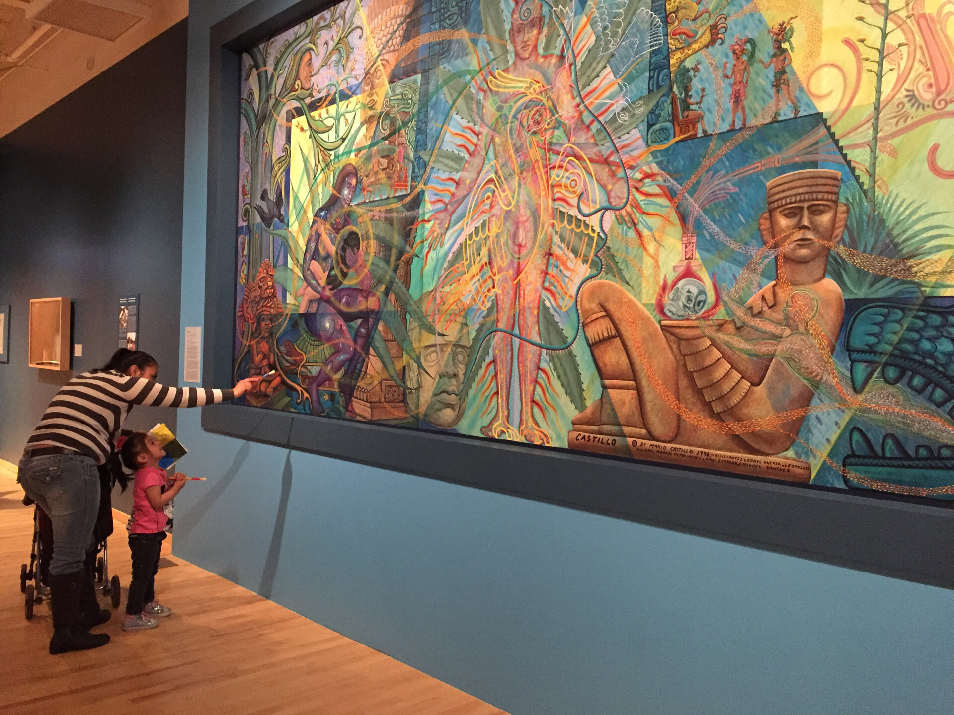 Photo of mom and child looking at painting in Nuestras Historias