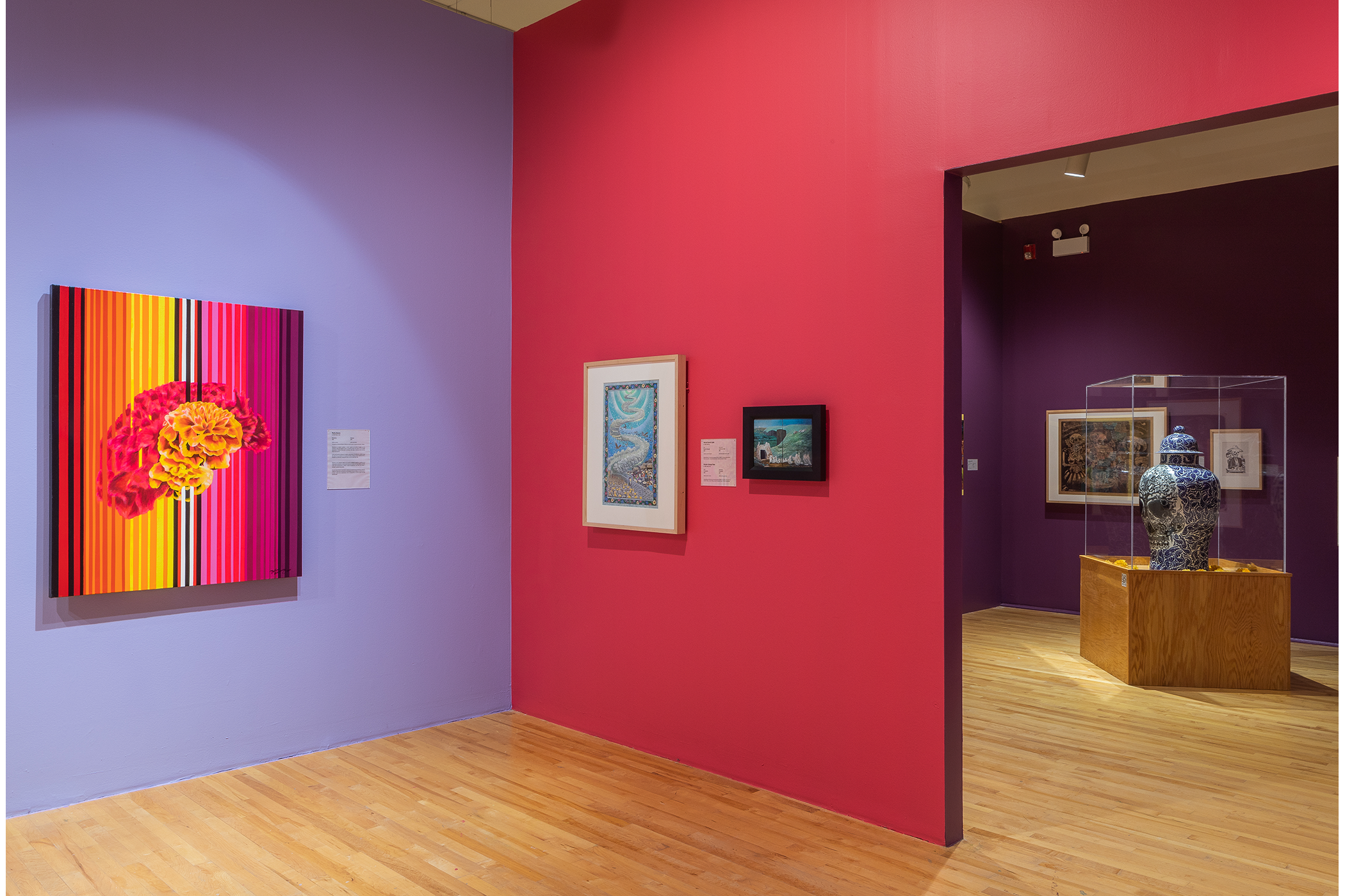 A corner with three paintings on display.