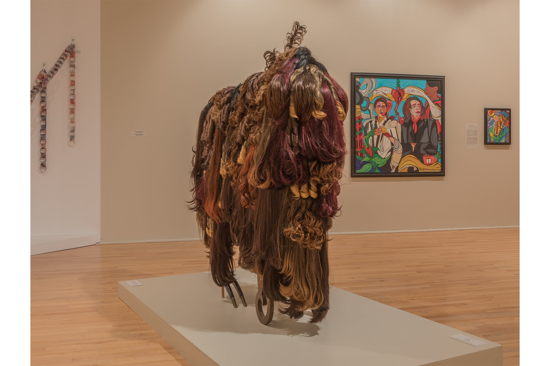 close up of the buffalo sculpture artwork with other pieces hanging in the background