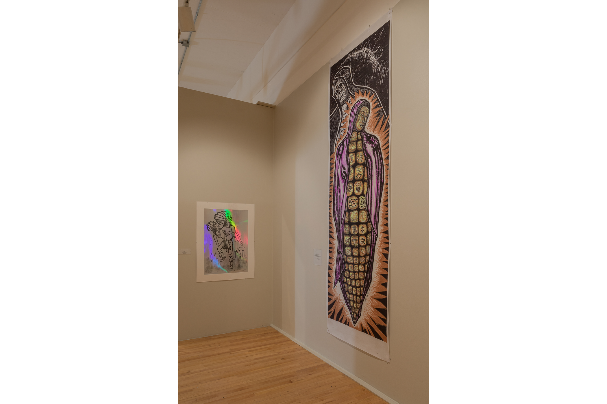 Two artworks: acrylic painting depicting a warrior holding his love, a painting of the virgin mary in the shape of a piece of corn.