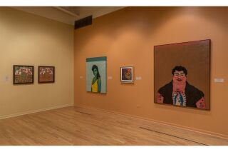 Left: two artworks hang on a beige wall. Right: three artworks hang on a terra cotta wall.
