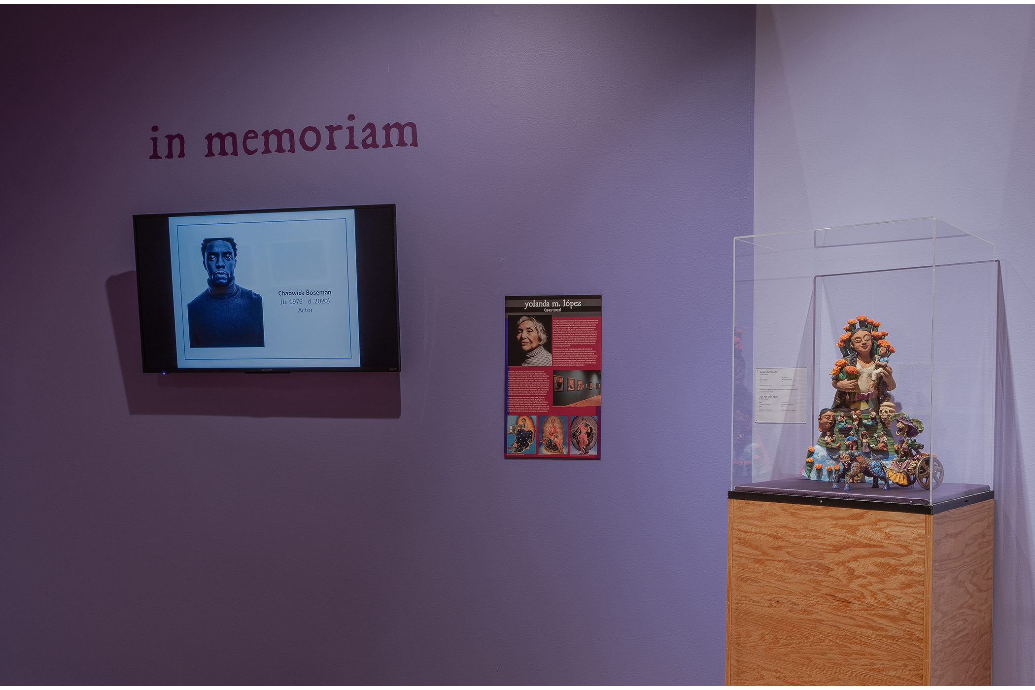 A monitor that rotates through images of people who have passed next to a ceramic structure