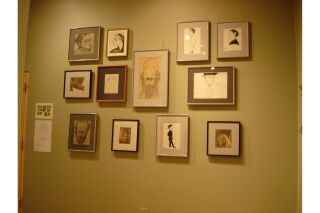 Image of gallery wall with cluster of twelve drawings